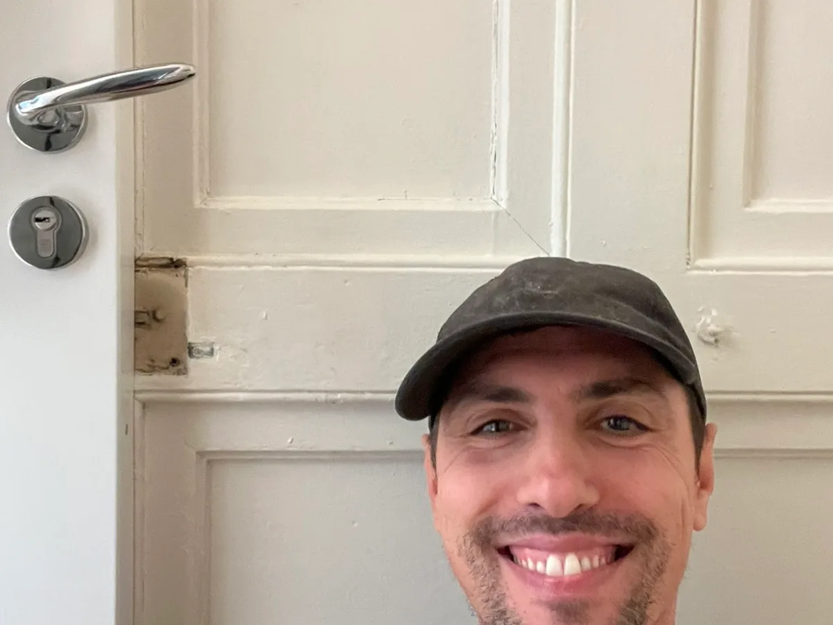 Benoît, artisan serrurier, devant une porte ancienne à Nice